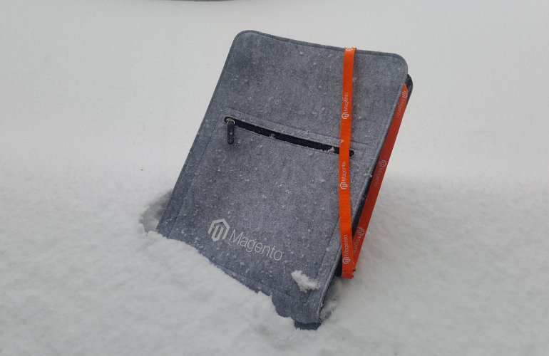A canvas Magento notebook sticking out of the sand