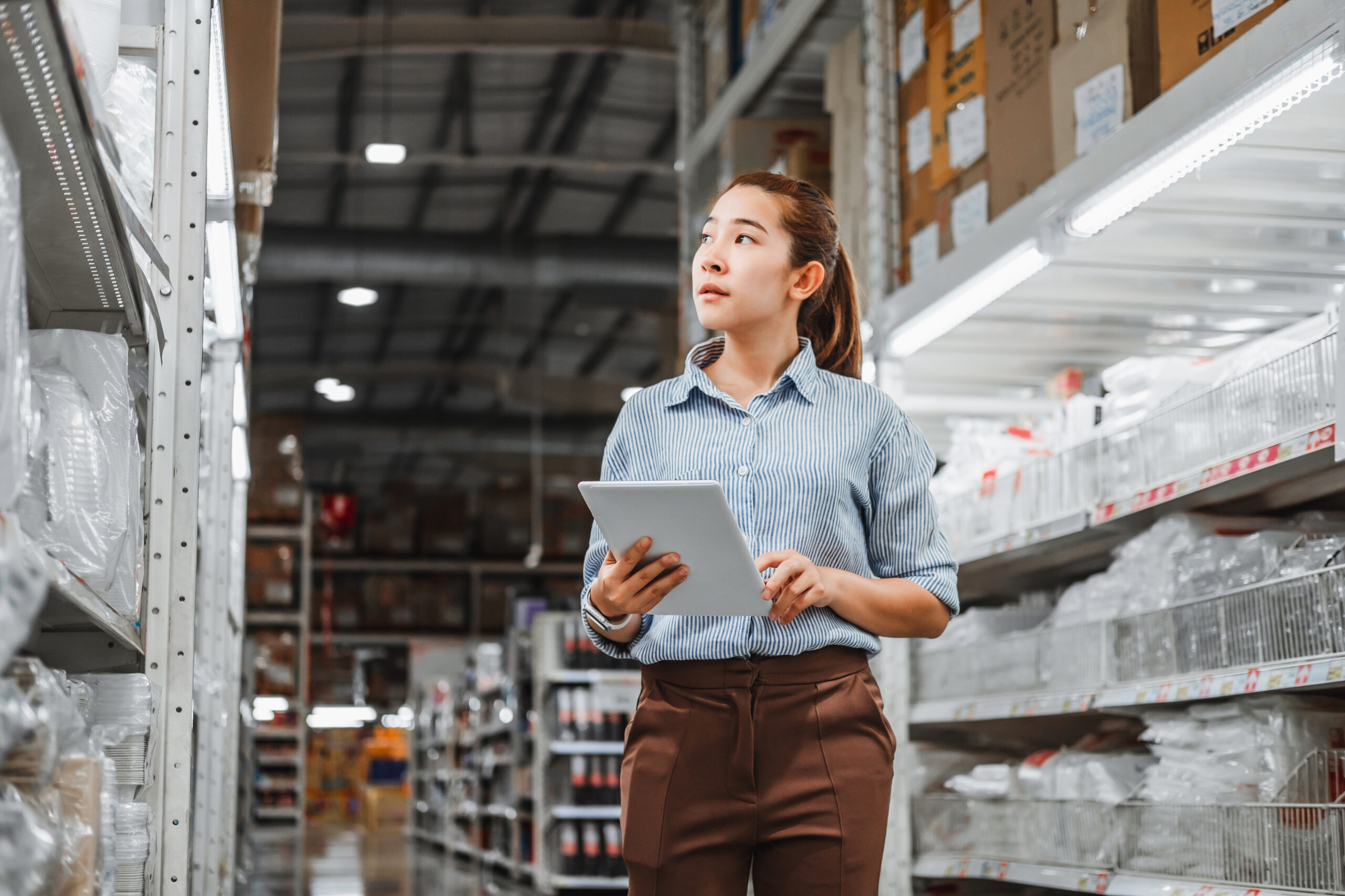 Woman holding a table in a warehouse
