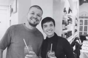 Man and woman holding drinks and smiling