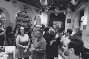 Room full of people at a cocktail hour socialising
